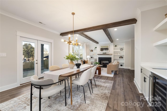 dining space featuring beam ceiling, french doors, dark wood-type flooring, beverage cooler, and a chandelier