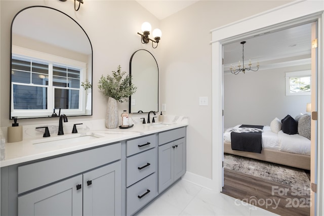 bathroom with vanity and an inviting chandelier