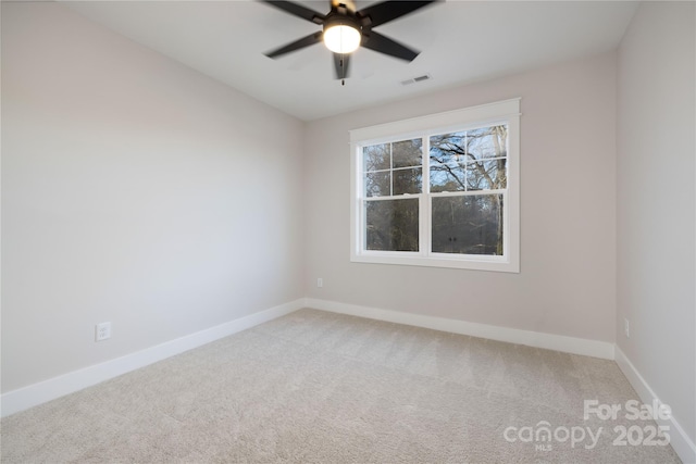 carpeted spare room with ceiling fan