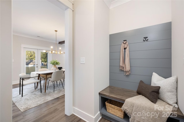 mudroom featuring crown molding, french doors, a chandelier, and hardwood / wood-style flooring