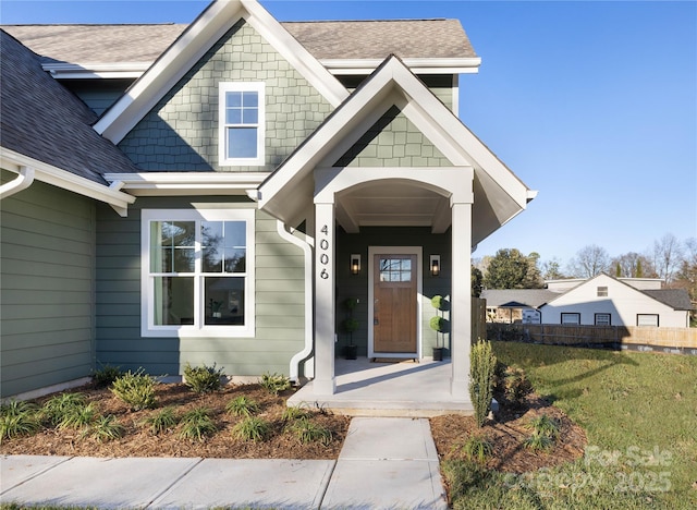 property entrance with a lawn