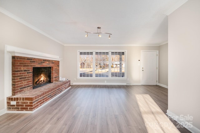 unfurnished living room featuring a brick fireplace, hardwood / wood-style flooring, and ornamental molding