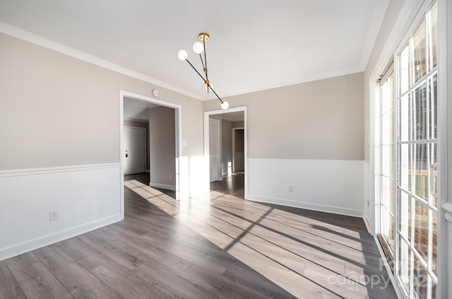 empty room featuring ornamental molding and wood-type flooring