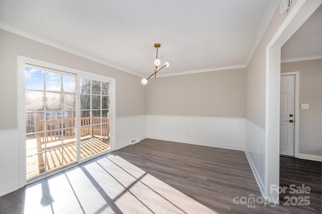 unfurnished dining area featuring a notable chandelier, crown molding, and dark hardwood / wood-style floors