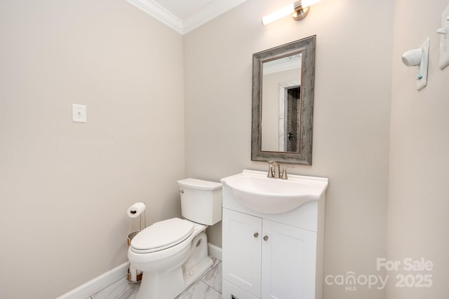 bathroom featuring vanity, crown molding, and toilet