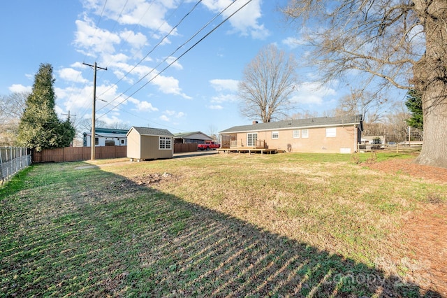 view of yard with a wooden deck and a shed