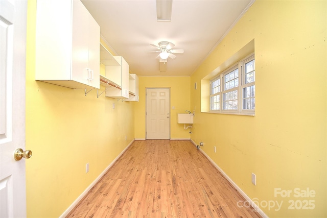 interior space featuring ceiling fan, sink, and light hardwood / wood-style flooring