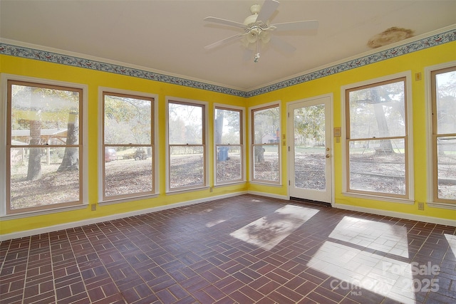 unfurnished sunroom with a wealth of natural light and ceiling fan