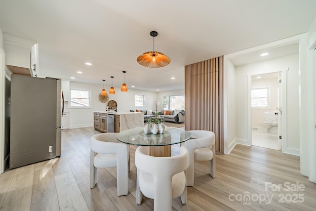 dining room featuring plenty of natural light and light hardwood / wood-style floors