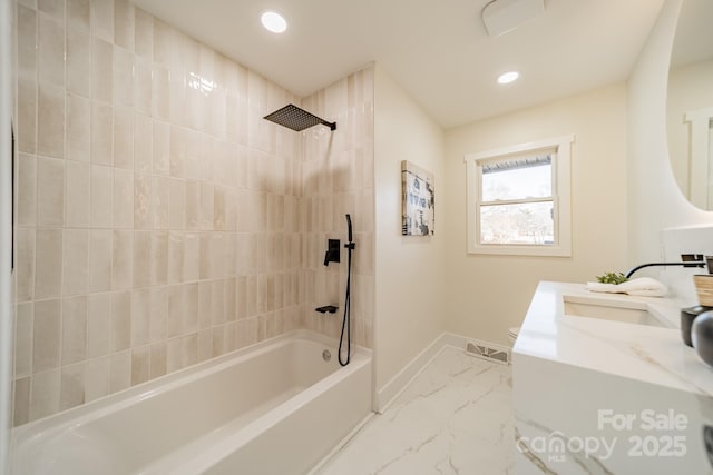 bathroom with vanity and tiled shower / bath