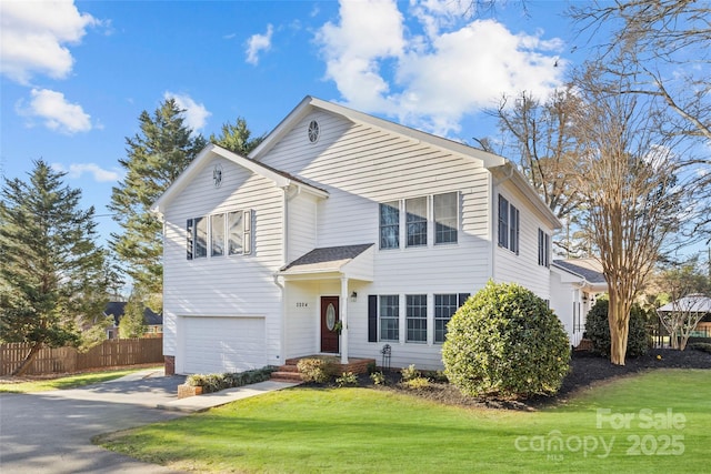 front of property featuring a front lawn and a garage