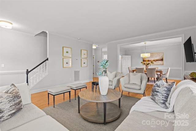 living room with ornamental molding and hardwood / wood-style flooring