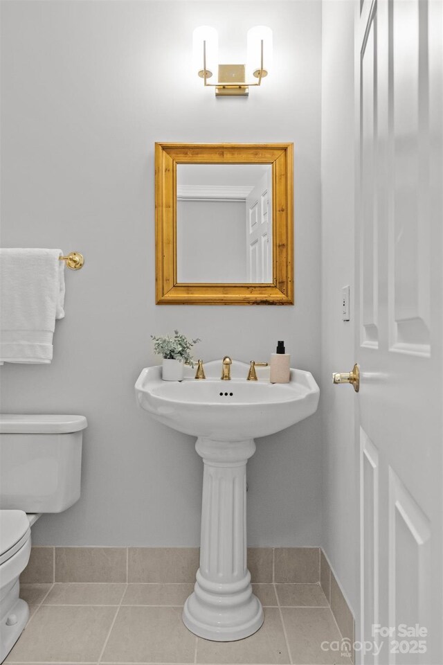 bathroom featuring toilet and tile patterned flooring