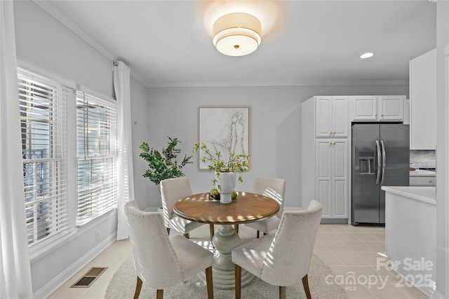 tiled dining space with crown molding