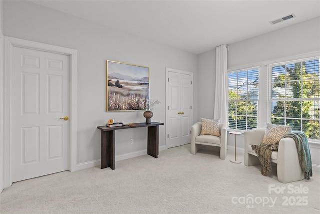 sitting room with light colored carpet