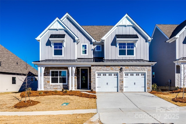 modern farmhouse with a standing seam roof, metal roof, board and batten siding, and driveway