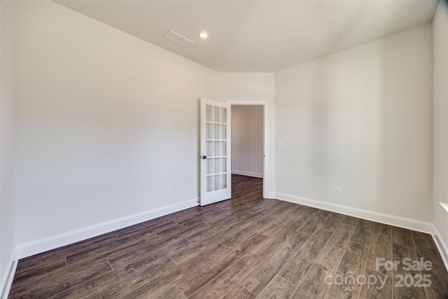 spare room featuring dark wood-style floors, french doors, recessed lighting, and baseboards