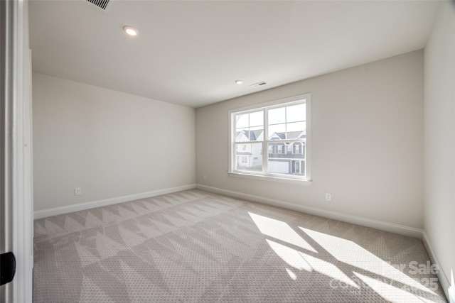 unfurnished room with light colored carpet, visible vents, baseboards, and recessed lighting