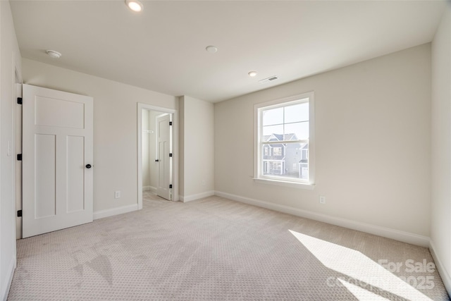 empty room featuring visible vents, baseboards, and carpet flooring