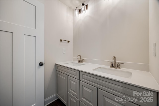 bathroom featuring a sink and double vanity