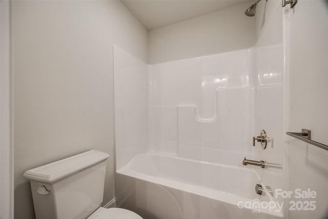 bathroom with bathtub / shower combination and toilet