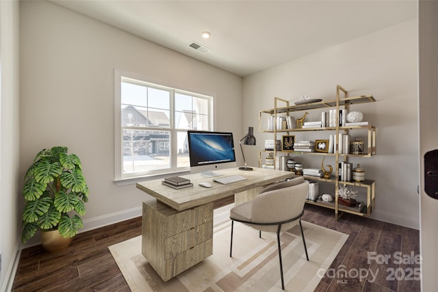 office space with dark wood-style flooring, visible vents, and baseboards