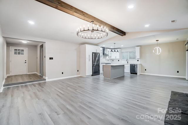 unfurnished living room with sink, lofted ceiling with beams, light hardwood / wood-style floors, and a notable chandelier