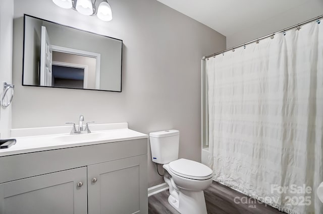 full bathroom featuring shower / bath combo, hardwood / wood-style floors, vanity, and toilet