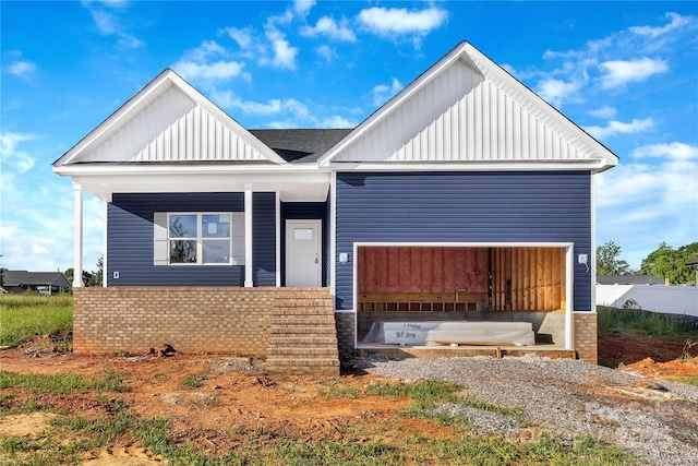 149 Tranquility Ln, Harmony, NC 28634 - view of front of house with board and batten siding, a porch, roof with shingles, and a garage