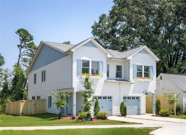 view of front of home featuring a garage and a front yard