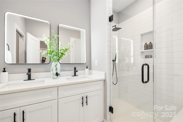 bathroom with vanity and a shower with door