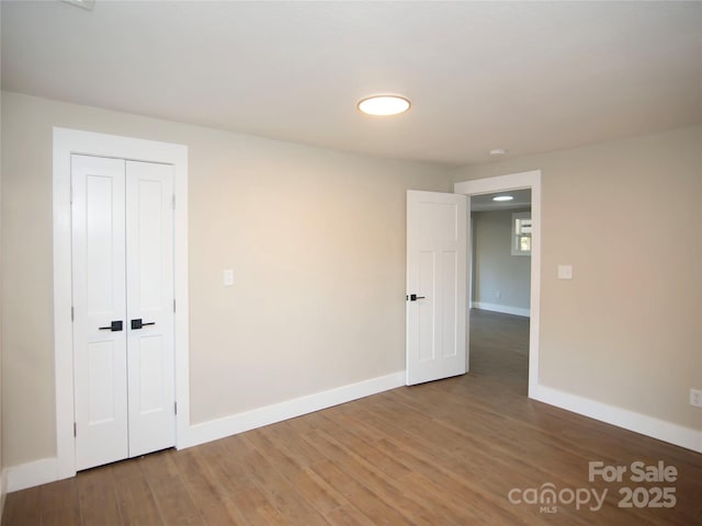 empty room with dark hardwood / wood-style flooring