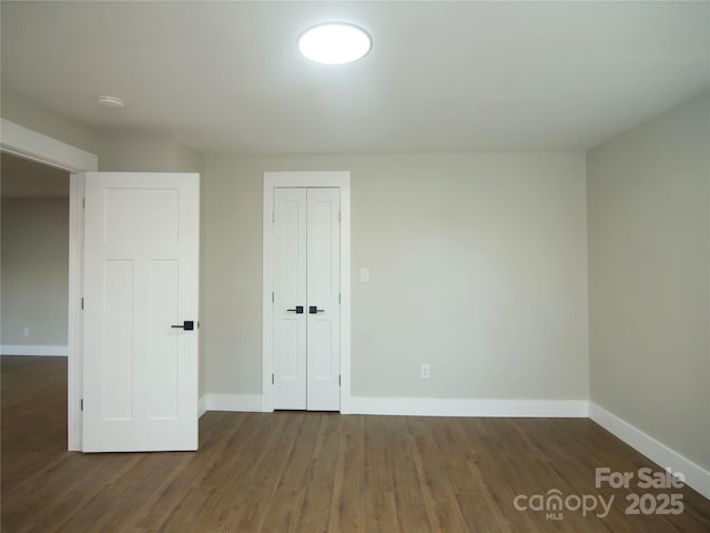 interior space featuring dark hardwood / wood-style flooring and a closet