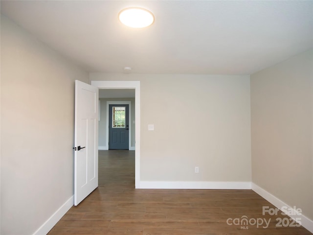 empty room featuring dark wood-type flooring