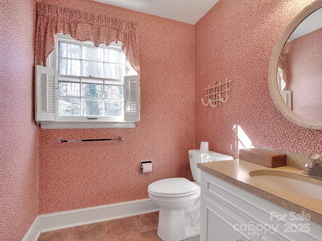 bathroom featuring tile patterned flooring, vanity, and toilet