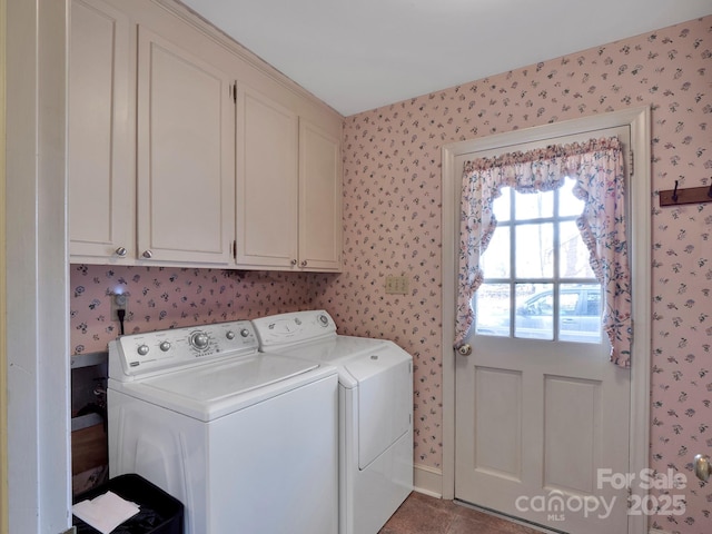 clothes washing area featuring cabinets and separate washer and dryer