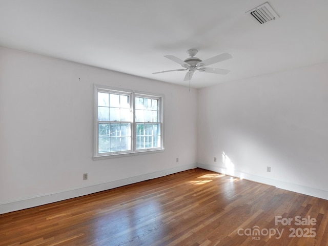 empty room with ceiling fan and hardwood / wood-style floors