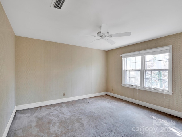 empty room featuring light carpet and ceiling fan