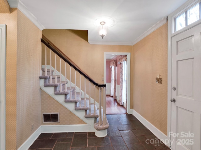 foyer featuring ornamental molding