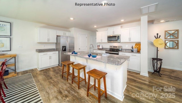 kitchen featuring sink, white cabinetry, a kitchen island with sink, and appliances with stainless steel finishes