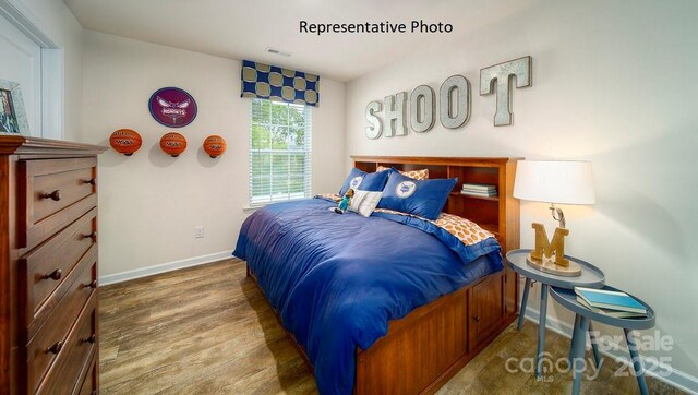 bedroom with hardwood / wood-style flooring