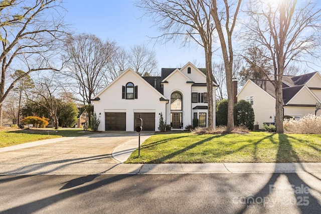 view of front of property with a front lawn and a garage