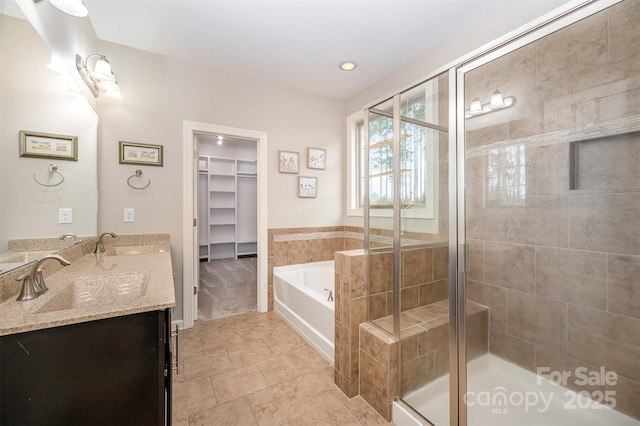 bathroom featuring vanity and shower with separate bathtub