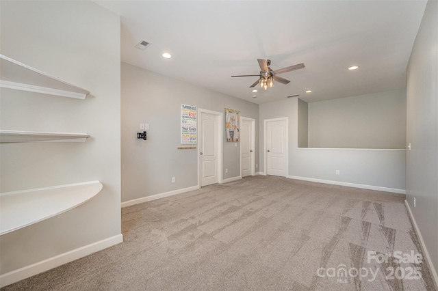 carpeted empty room featuring ceiling fan