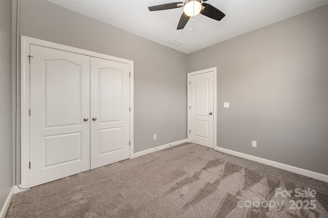 unfurnished bedroom featuring carpet floors, a closet, and ceiling fan