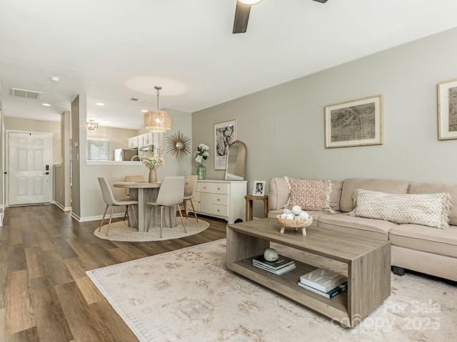 living room with ceiling fan and hardwood / wood-style flooring