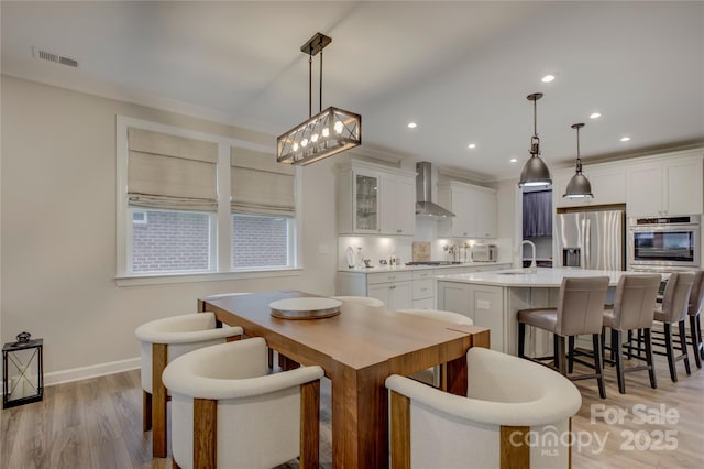 dining room featuring light wood-type flooring and sink