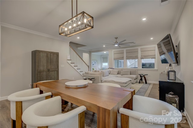 dining area featuring ceiling fan, light hardwood / wood-style flooring, and ornamental molding