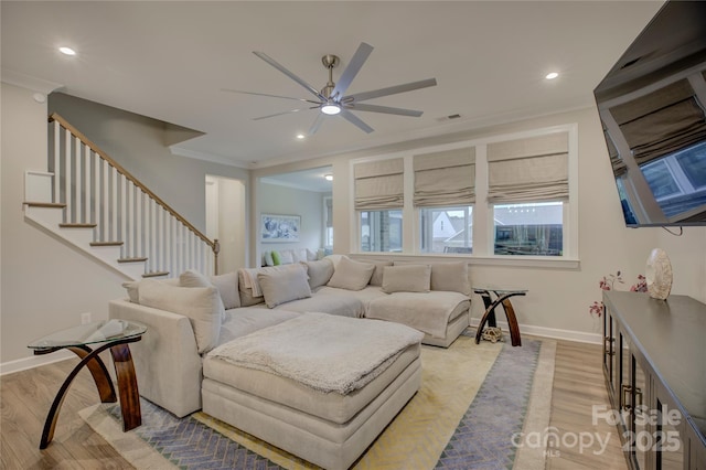 living room with ceiling fan, light hardwood / wood-style flooring, and ornamental molding