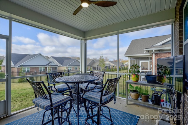 sunroom / solarium with ceiling fan and a healthy amount of sunlight